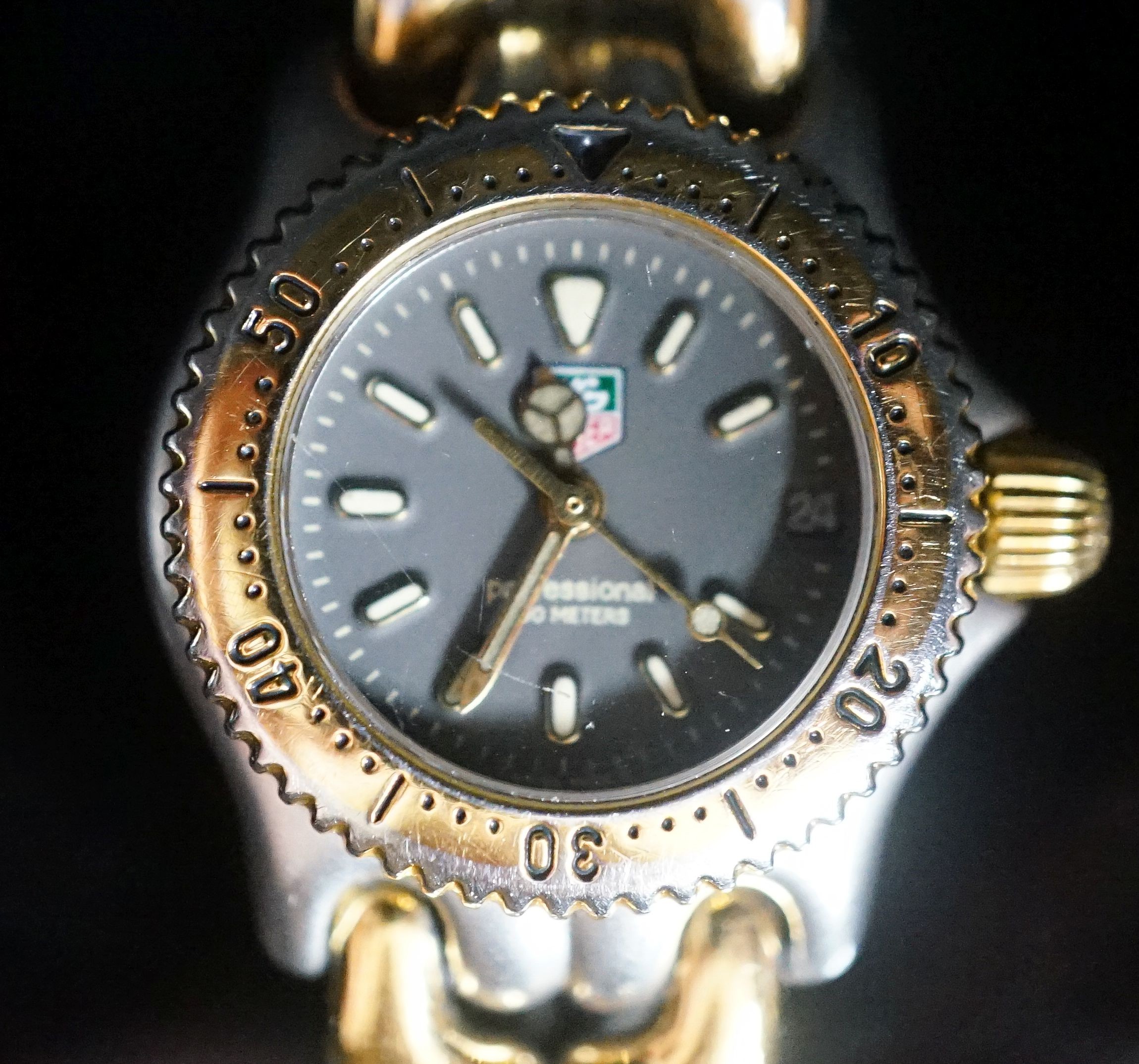 A lady's modern steel and gold plated Tag Heuer Professional quartz wrist watch, no box or papers.